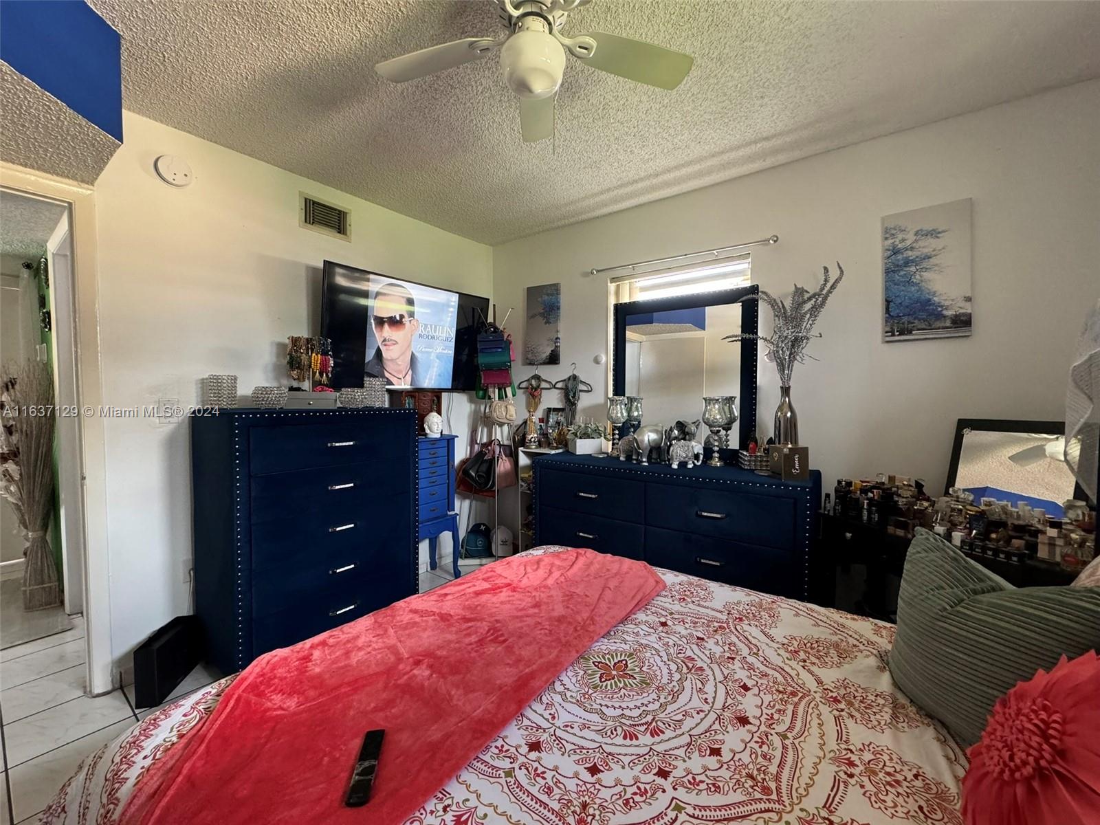 231 East 7th Street Hialeah, FL 33010 - Photo 33 of 39 a bed room with a bed and a dresser