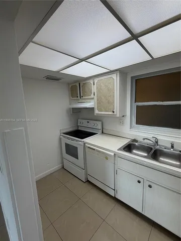a kitchen with cabinets and sink