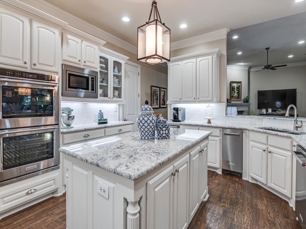 701 Regency Court Denton, TX 76210 - Photo 11 of 39 a kitchen with stainless steel appliances granite countertop a sink stove and refrigerator