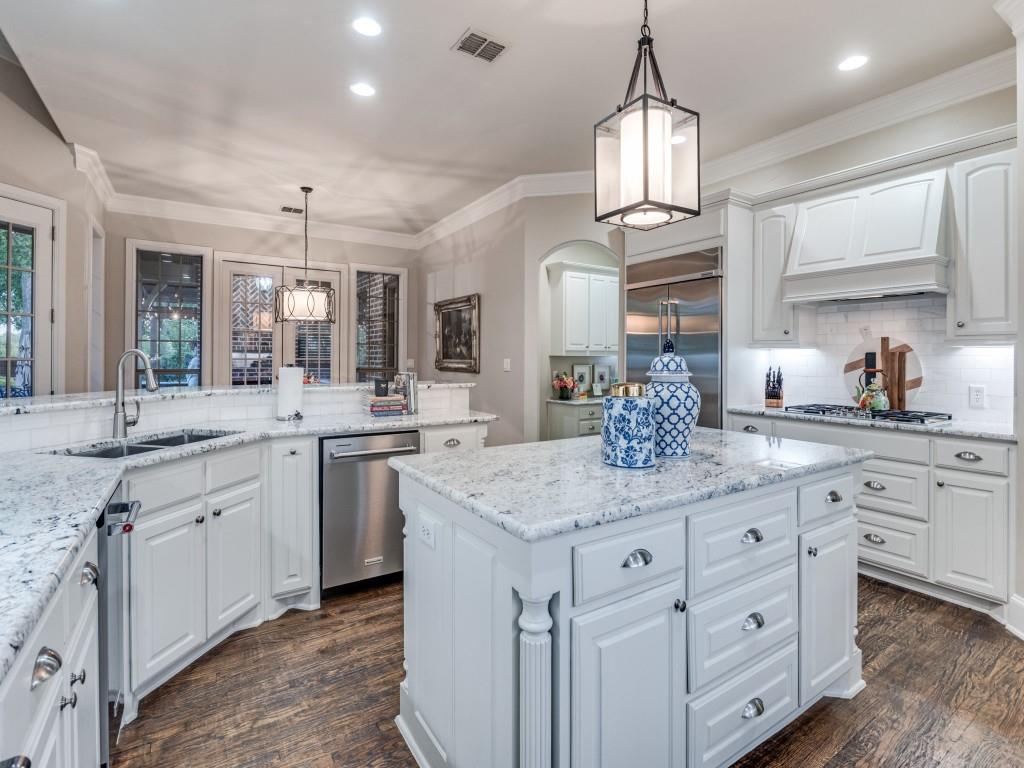701 Regency Court Denton, TX 76210 - Photo 12 of 39 a kitchen with kitchen island granite countertop a stove a sink a island and windows