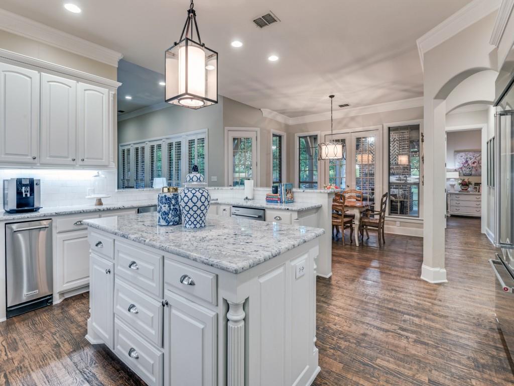 701 Regency Court Denton, TX 76210 - Photo 13 of 39 a kitchen with center island table and chairs