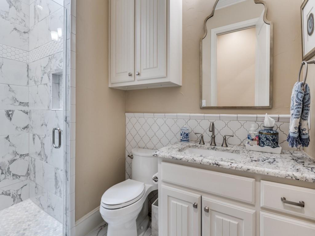 701 Regency Court Denton, TX 76210 - Photo 23 of 39 a bathroom with a granite countertop toilet sink and mirror