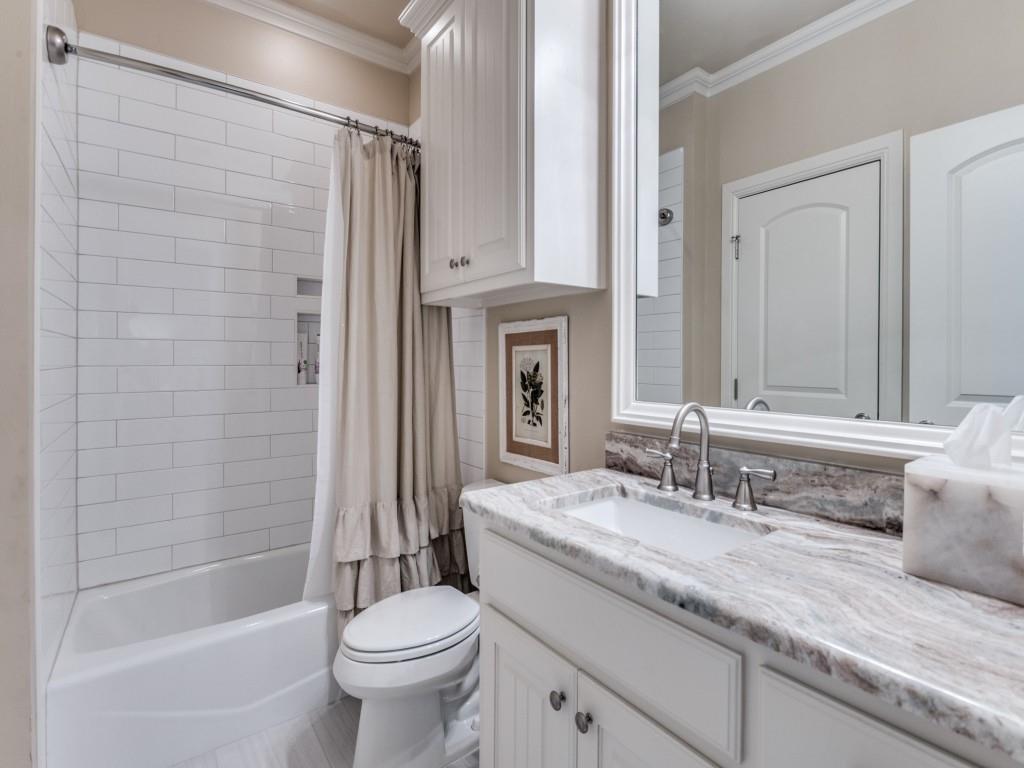 701 Regency Court Denton, TX 76210 - Photo 25 of 39 a bathroom with a granite countertop sink a toilet a mirror and bathtub