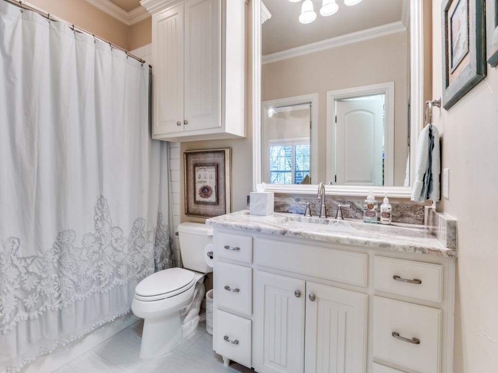 701 Regency Court Denton, TX 76210 - Photo 27 of 39 a spacious bathroom with a toilet a sink and a mirror