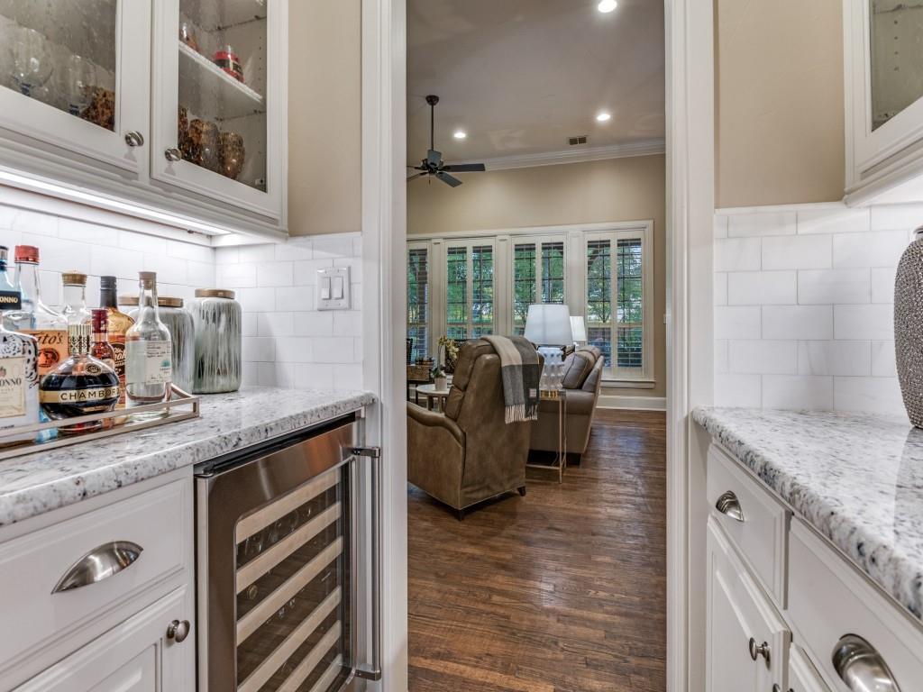 701 Regency Court Denton, TX 76210 - Photo 7 of 39 a kitchen with sink refrigerator and cabinets