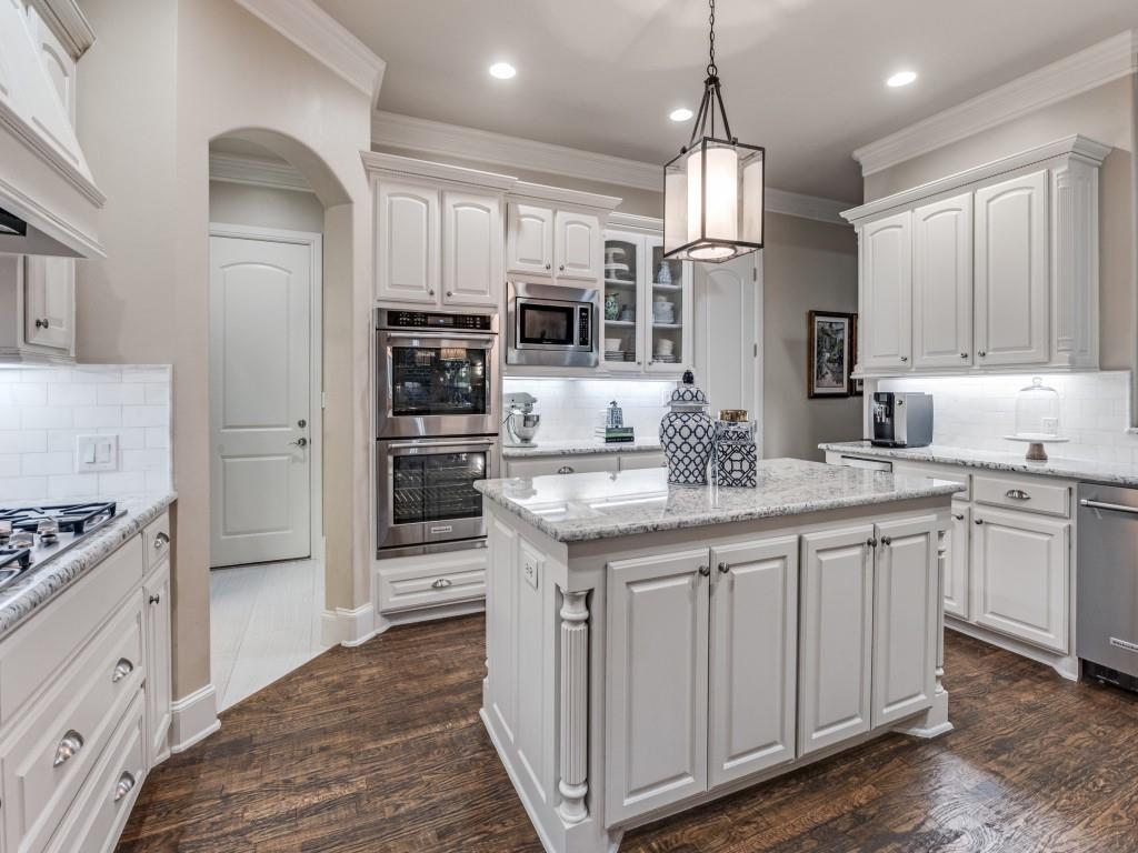 701 Regency Court Denton, TX 76210 - Photo 10 of 39 a kitchen with stainless steel appliances granite countertop a sink and cabinets
