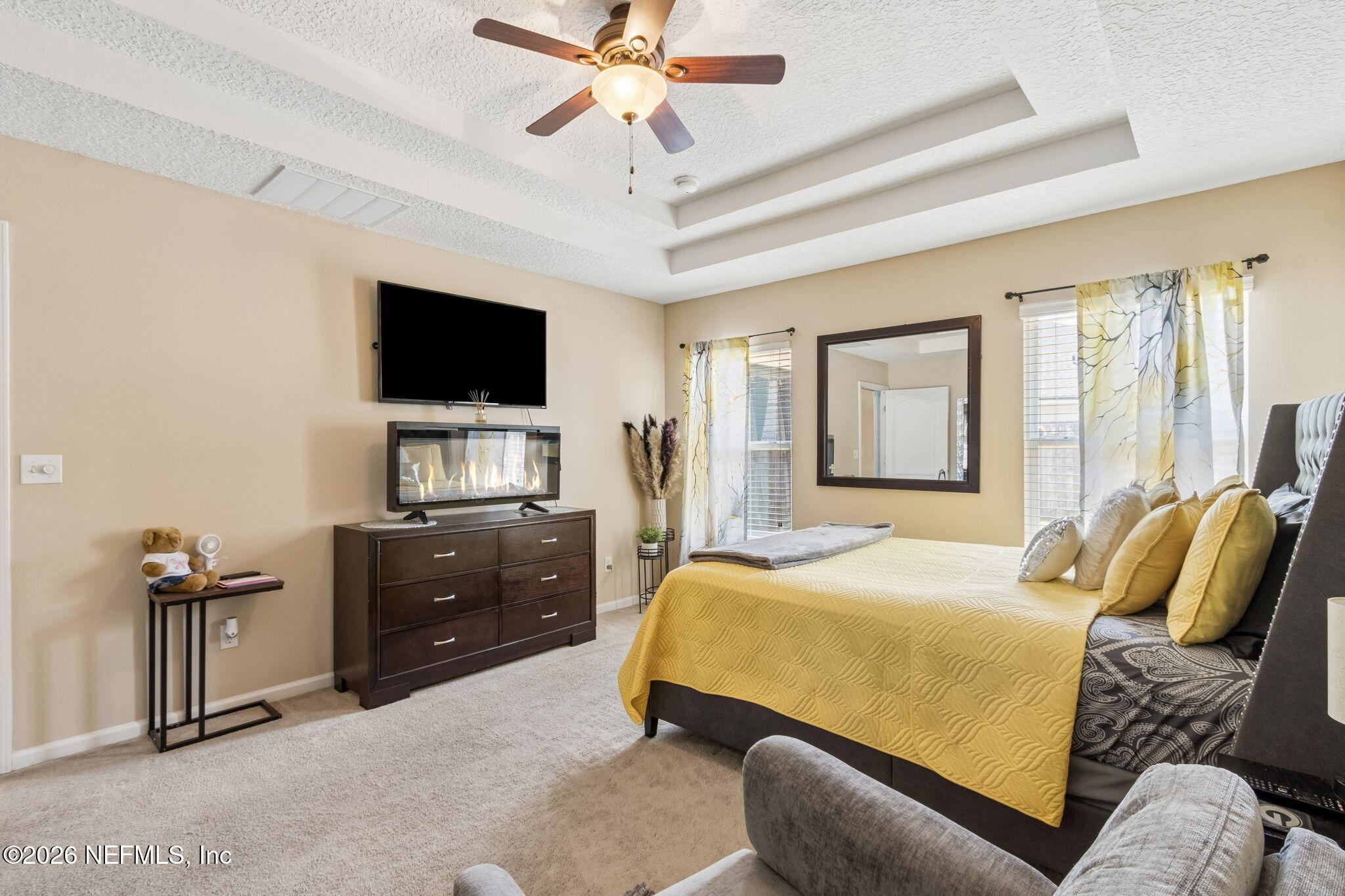96034 Bass Lane Yulee, FL 32097 - Photo 29 of 50 a bedroom with a bed and a flat screen tv