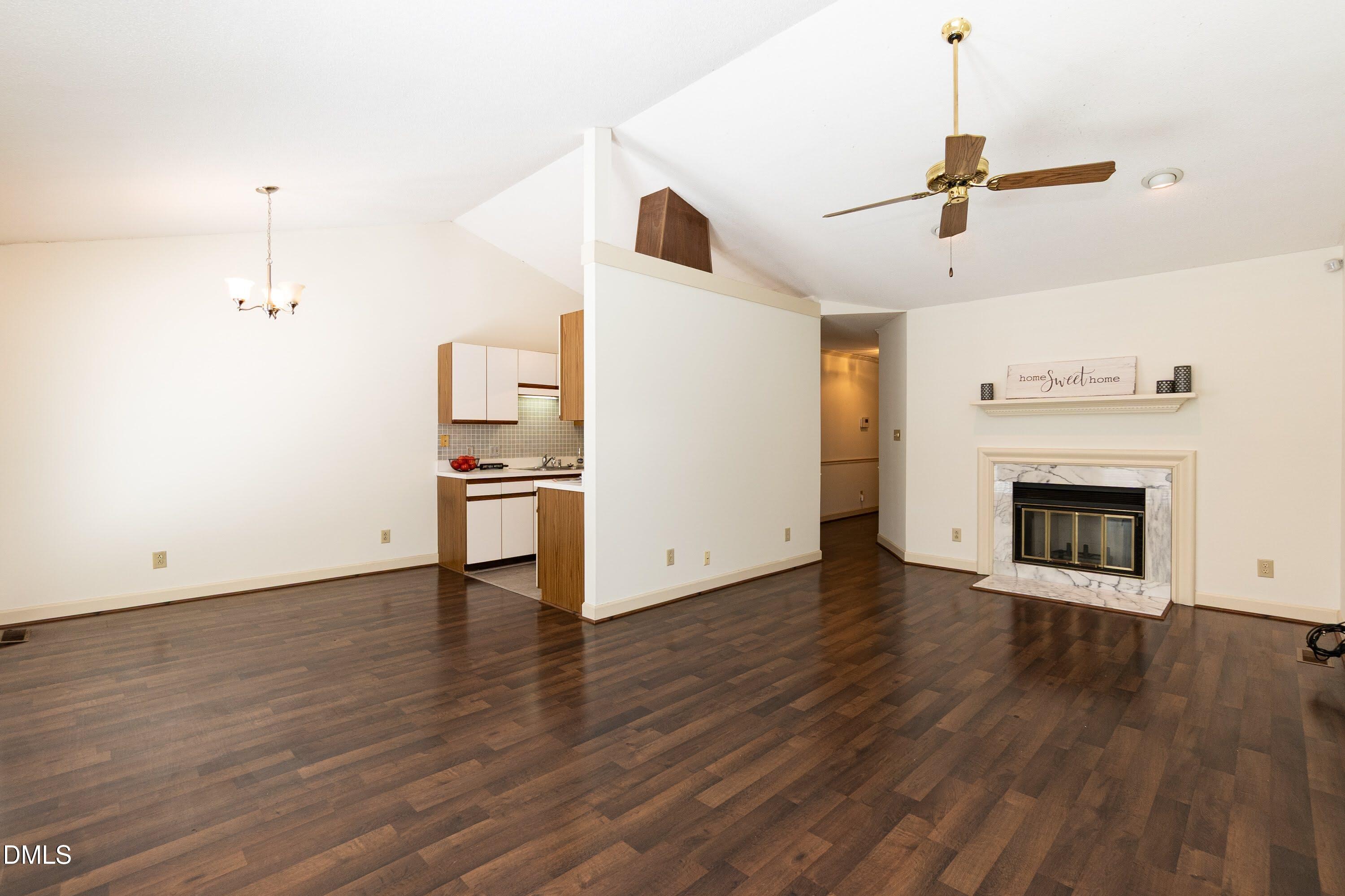 5604 Spring Pines Way Raleigh, NC 27616 - Photo 4 of 22 a view of empty room with wooden floor and fireplace