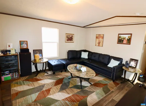 a living room with furniture a rug and a window