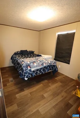 a bedroom with a bed and a night stand