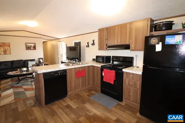 a kitchen with stainless steel appliances granite countertop a stove refrigerator and microwave