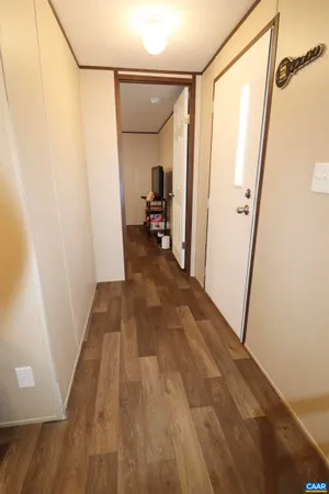 a view of a hallway view with wooden floor and staircase