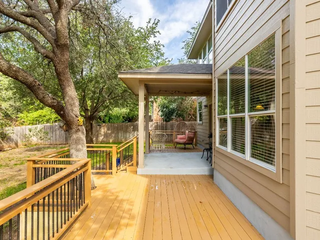 a view of a chairs and table on the wooden deck