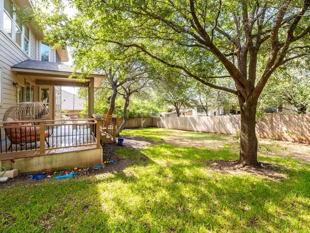 a view of a house with a yard patio and fire pit
