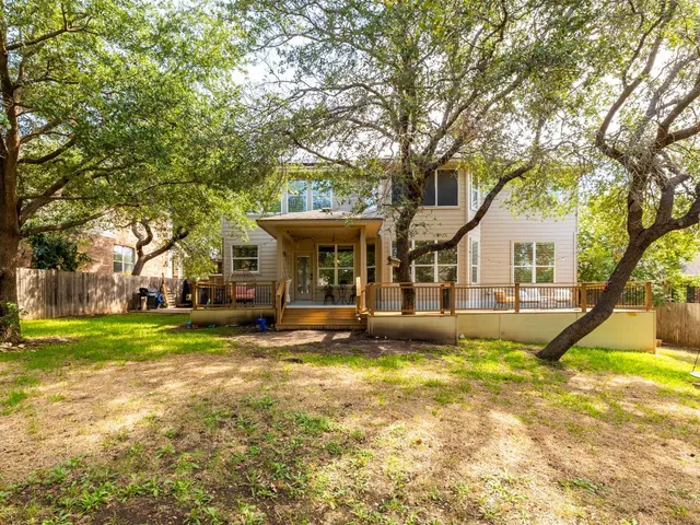 a view of a backyard with a garden and trees