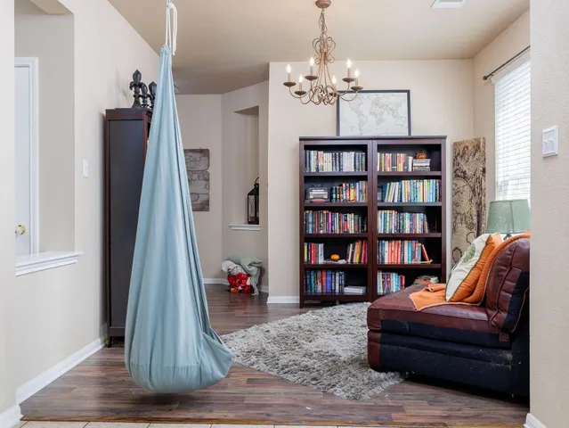 a living room with furniture and a wooden floor
