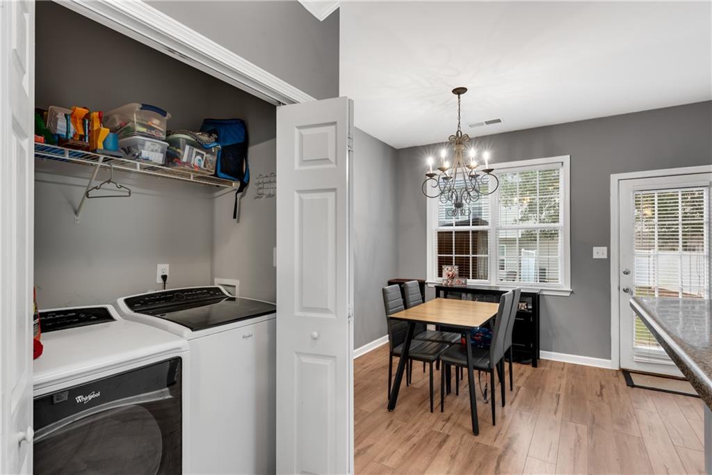 1791 Heights Circle Kennesaw, GA 30152 - Photo 11 of 24 a kitchen with a dining table chairs and a stove