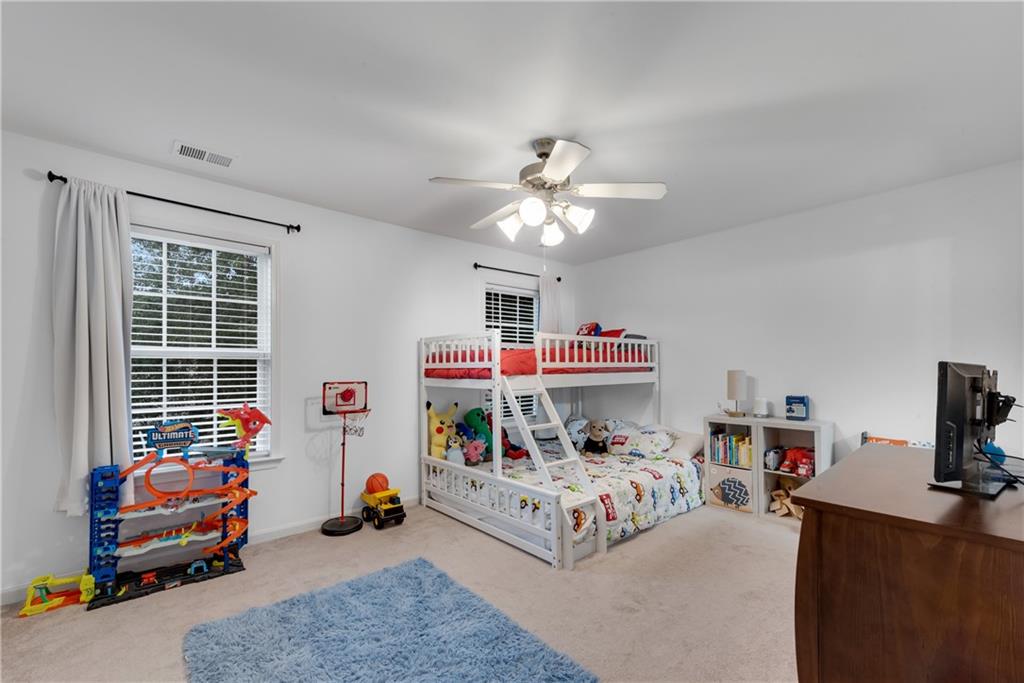 1791 Heights Circle Kennesaw, GA 30152 - Photo 19 of 24 a bedroom with furniture and a chandelier