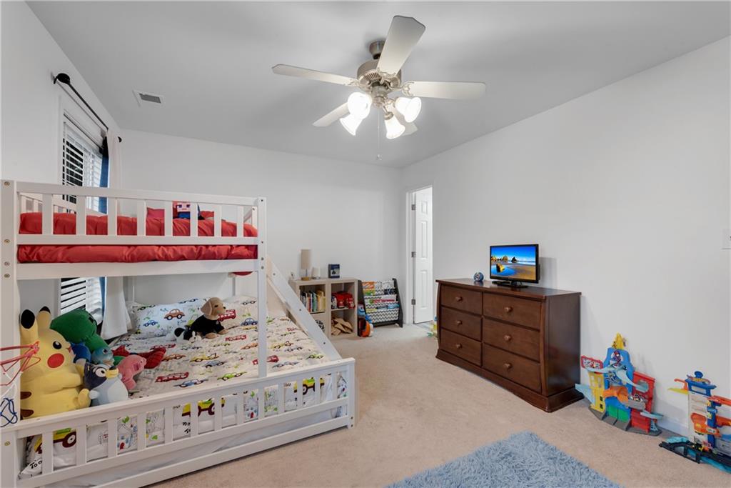 1791 Heights Circle Kennesaw, GA 30152 - Photo 20 of 24 a living room with furniture and a baby crib