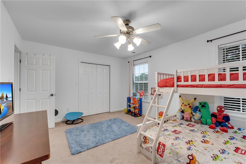 1791 Heights Circle Kennesaw, GA 30152 - Photo 21 of 24 a bedroom that has a bed and a table in it