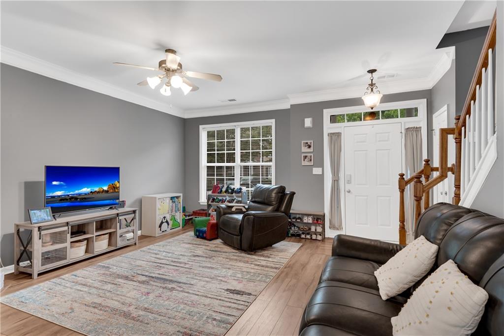 1791 Heights Circle Kennesaw, GA 30152 - Photo 5 of 24 a living room with furniture a flat screen tv and a fireplace