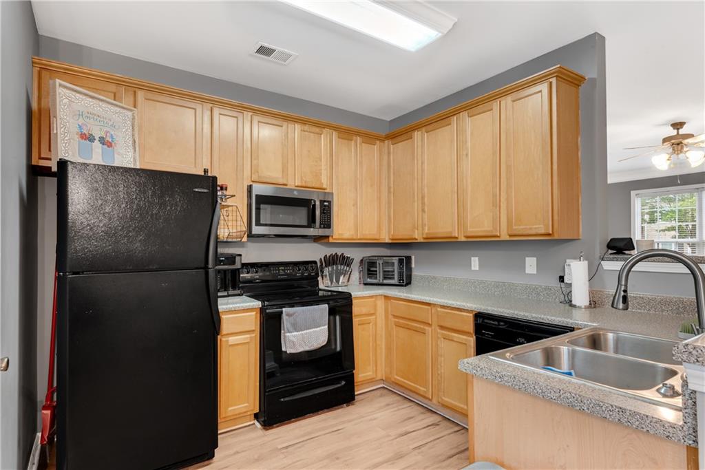 1791 Heights Circle Kennesaw, GA 30152 - Photo 9 of 24 a kitchen with a refrigerator sink and cabinets