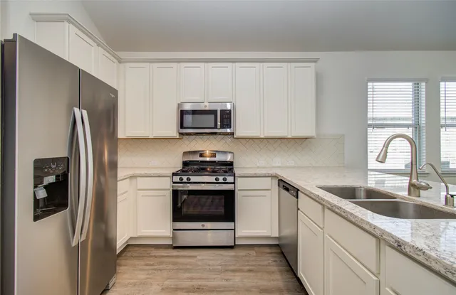 a white toilet and tub sitting next to a bathroom sink