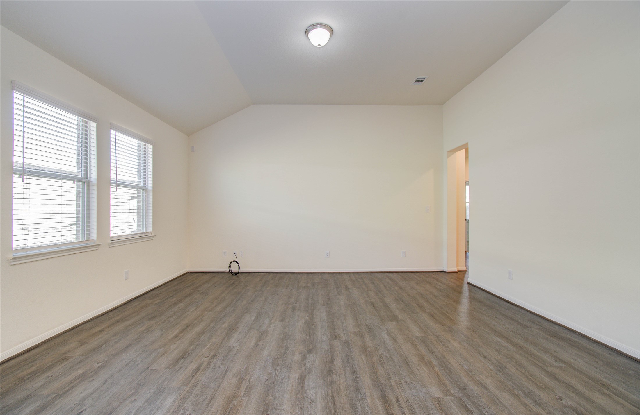 8426 Beacon Bay Circle Baytown, TX 77523 - Photo 17 of 36 an empty room with wooden floor and windows