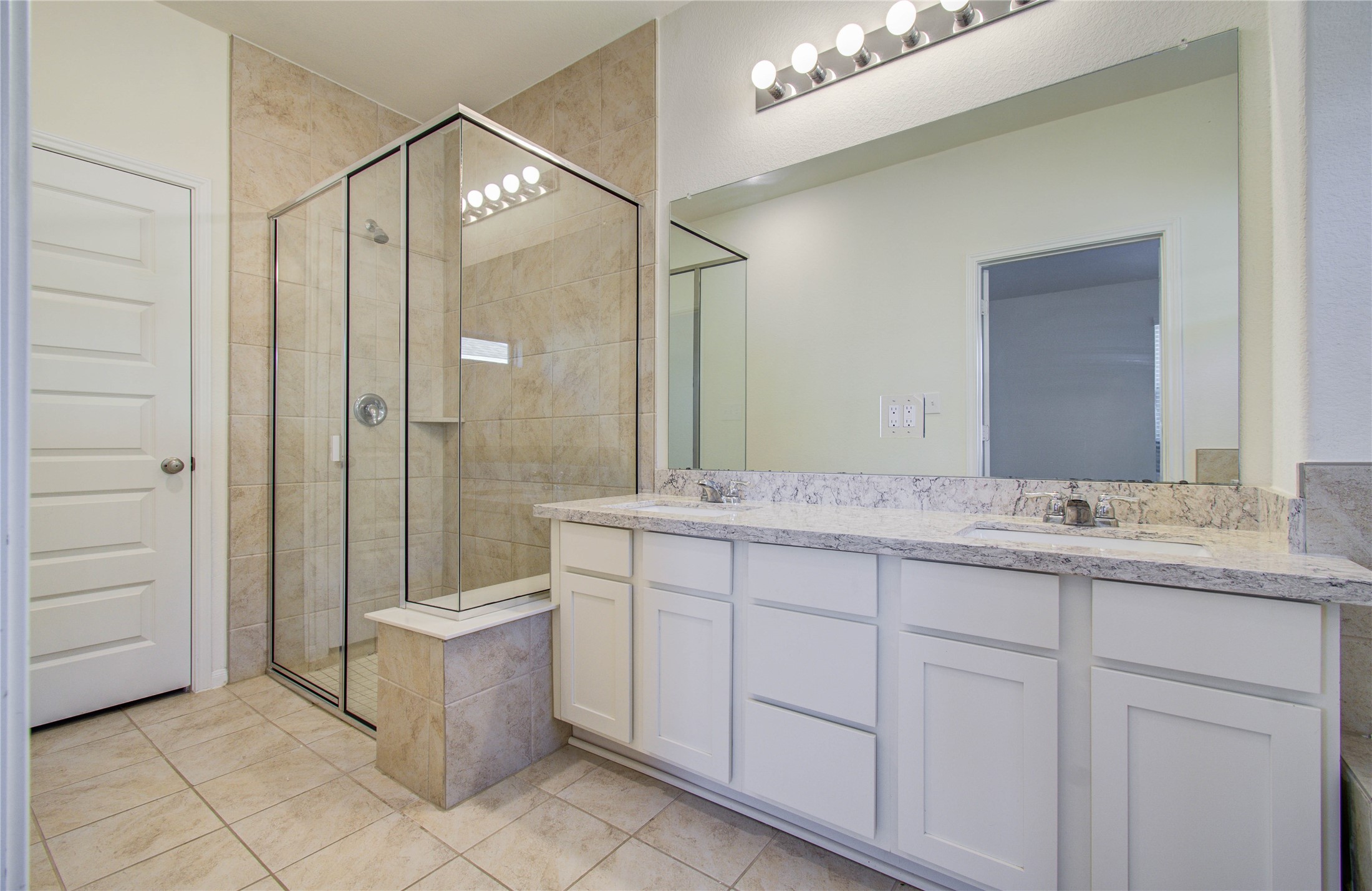 8426 Beacon Bay Circle Baytown, TX 77523 - Photo 22 of 36 a bathroom with a granite countertop sink a mirror and a bathtub