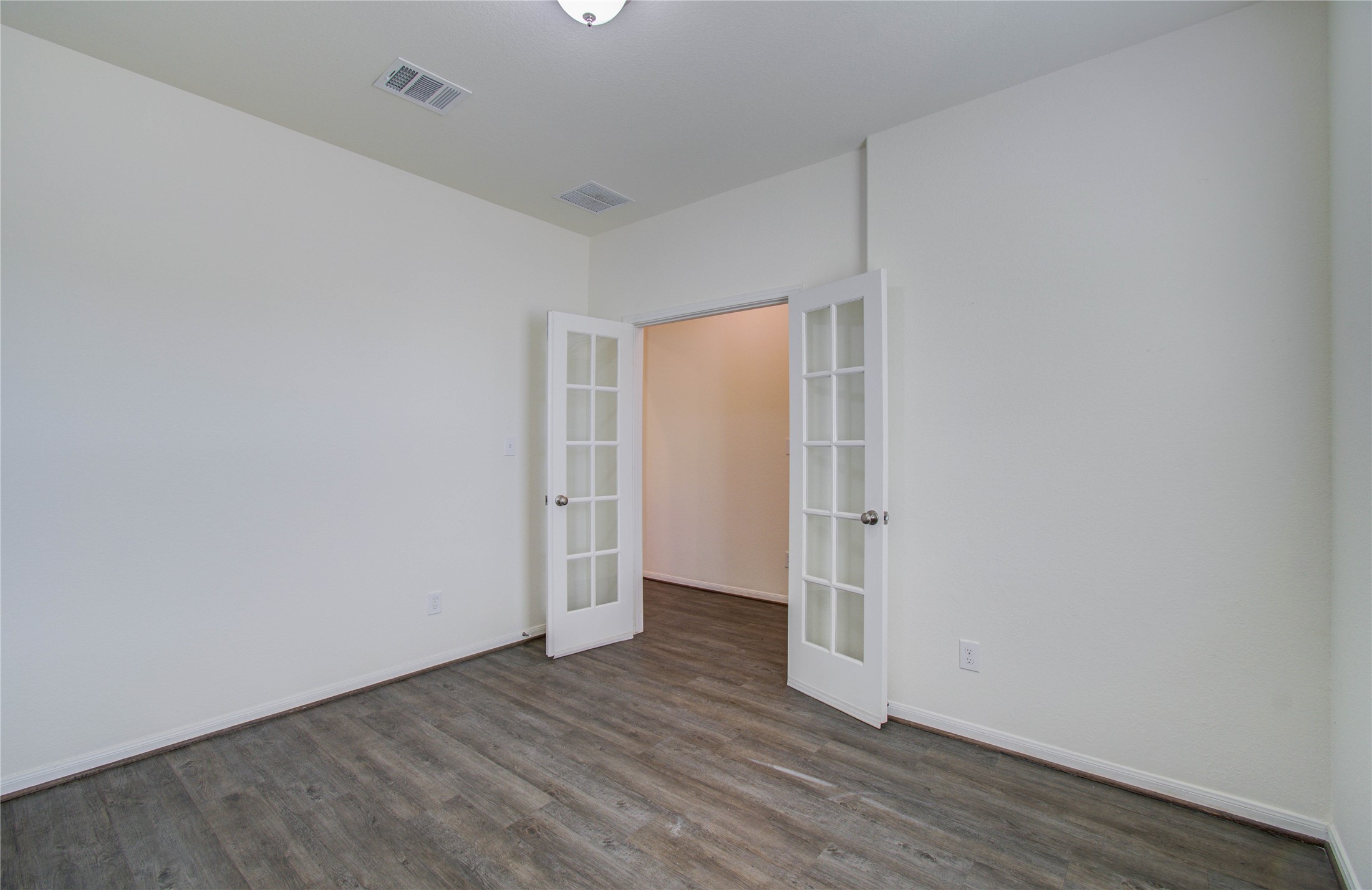 8426 Beacon Bay Circle Baytown, TX 77523 - Photo 7 of 36 a view of an empty room with wooden floor and closet