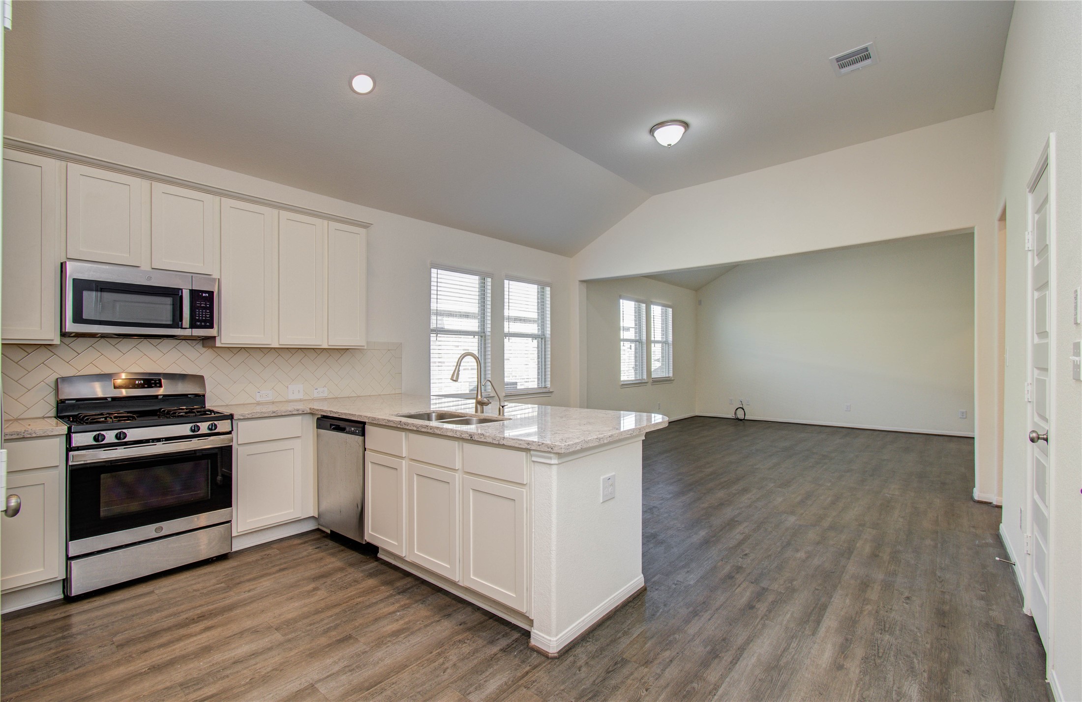 8426 Beacon Bay Circle Baytown, TX 77523 - Photo 9 of 36 a kitchen with stainless steel appliances granite countertop a stove and a sink