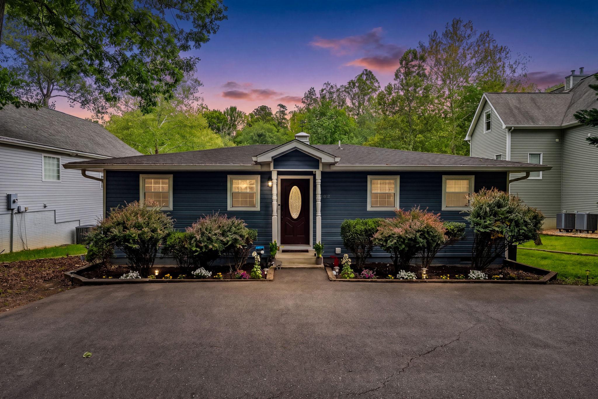 Charming home w/ lush greenery on the main lake.