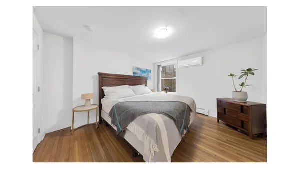 a bedroom with a large bed and a flat screen tv