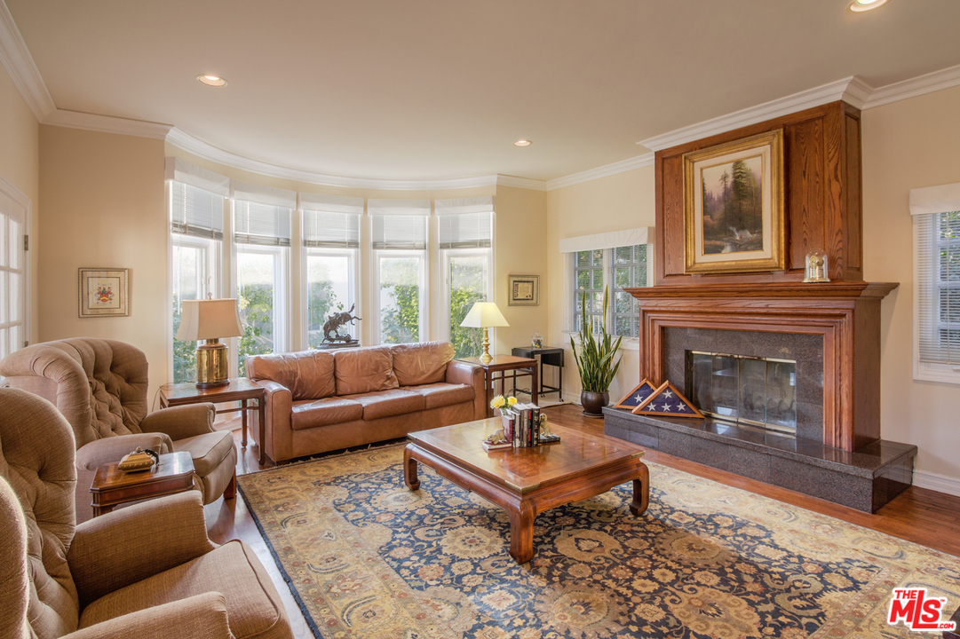 340 11th Street Santa Monica, CA 90402 - Photo 14 of 28 a living room with furniture a fireplace and a large window