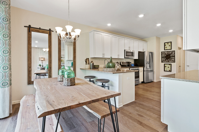 2021 Stuttle Road Batavia, IL 60510 - Photo 8 of 27 a kitchen with microwave a refrigerator and chairs