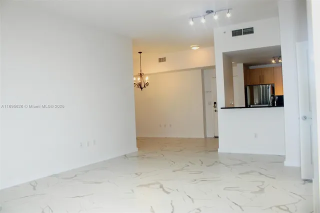 an empty room with wooden floor and closet