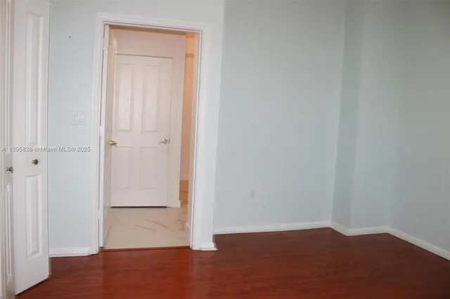 a view of a white house with a big yard and large trees