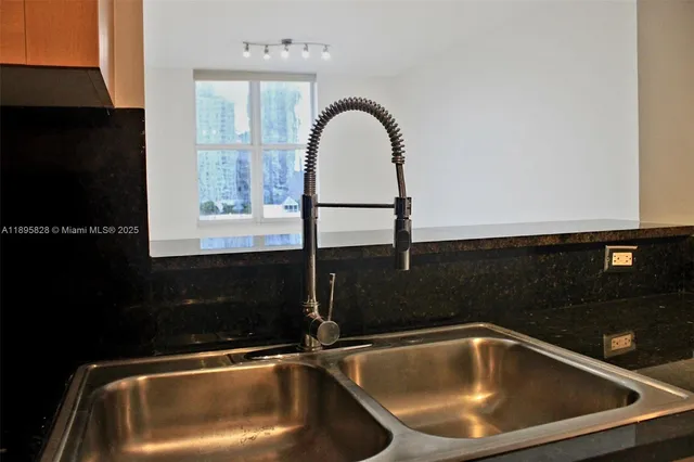 a bathroom with a granite countertop toilet and a shower