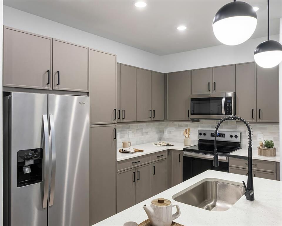 7260 Roswell Road, Unit S1 Sandy Springs, GA 30328 - Photo 18 of 23 a kitchen with stainless steel appliances granite countertop a refrigerator a sink a stove and white cabinets