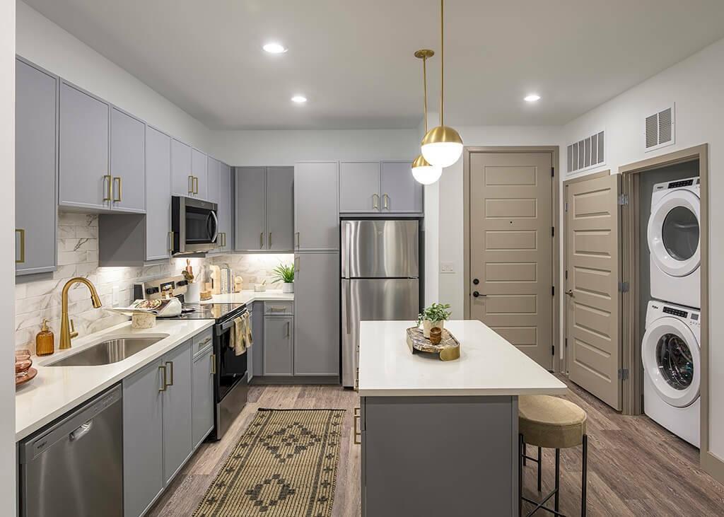 7260 Roswell Road, Unit S1 Sandy Springs, GA 30328 - Photo 19 of 23 a kitchen with kitchen island a sink a stove a refrigerator cabinets and washer