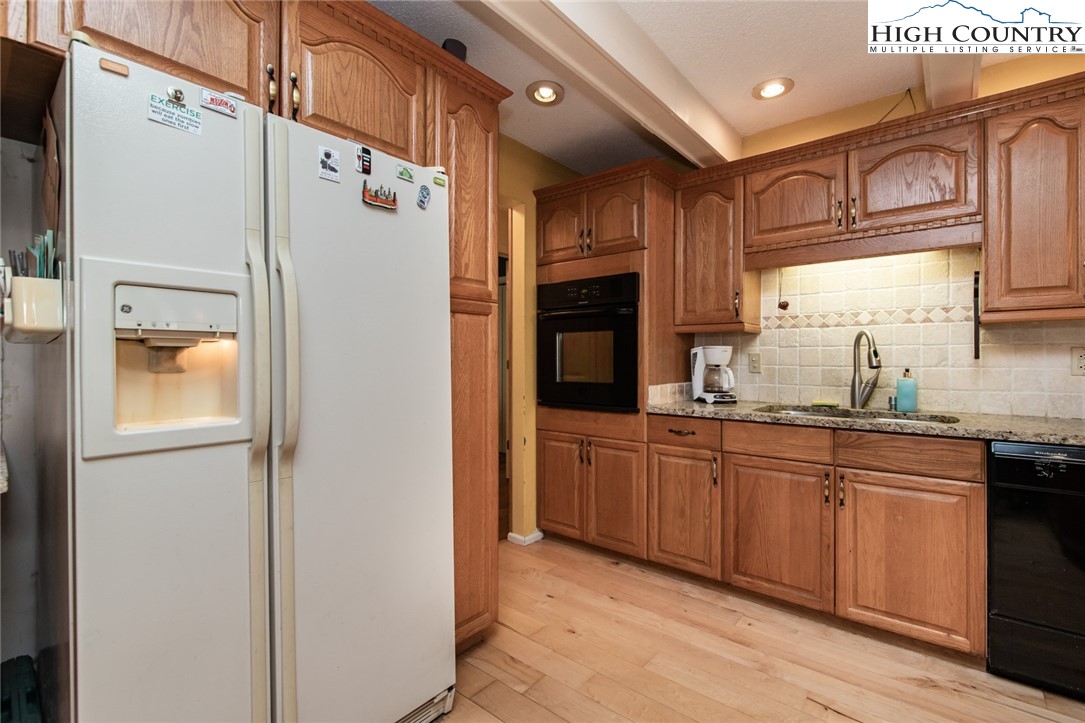 171 Trout Lake Road Deep Gap, NC 28618 - Photo 16 of 35 a kitchen with stainless steel appliances granite countertop a refrigerator and a sink
