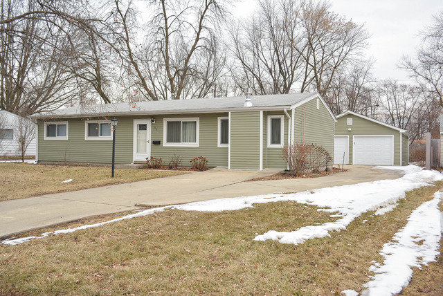 53 Sierra Road Montgomery, IL 60538 - Photo 1 of 25 a front view of a house with a garden and trees