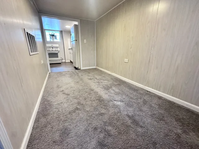 a view of a livingroom with wooden floor and staircase