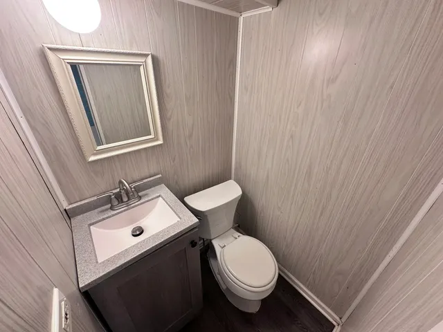 a bathroom with a sink a toilet and a mirror