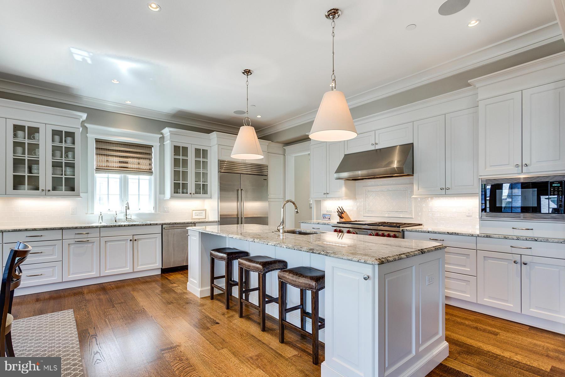 1909 Foxview Circle Northwest Washington, DC 20007 - Photo 12 of 30 a kitchen with stainless steel appliances granite countertop a stove a sink a center island and cabinets