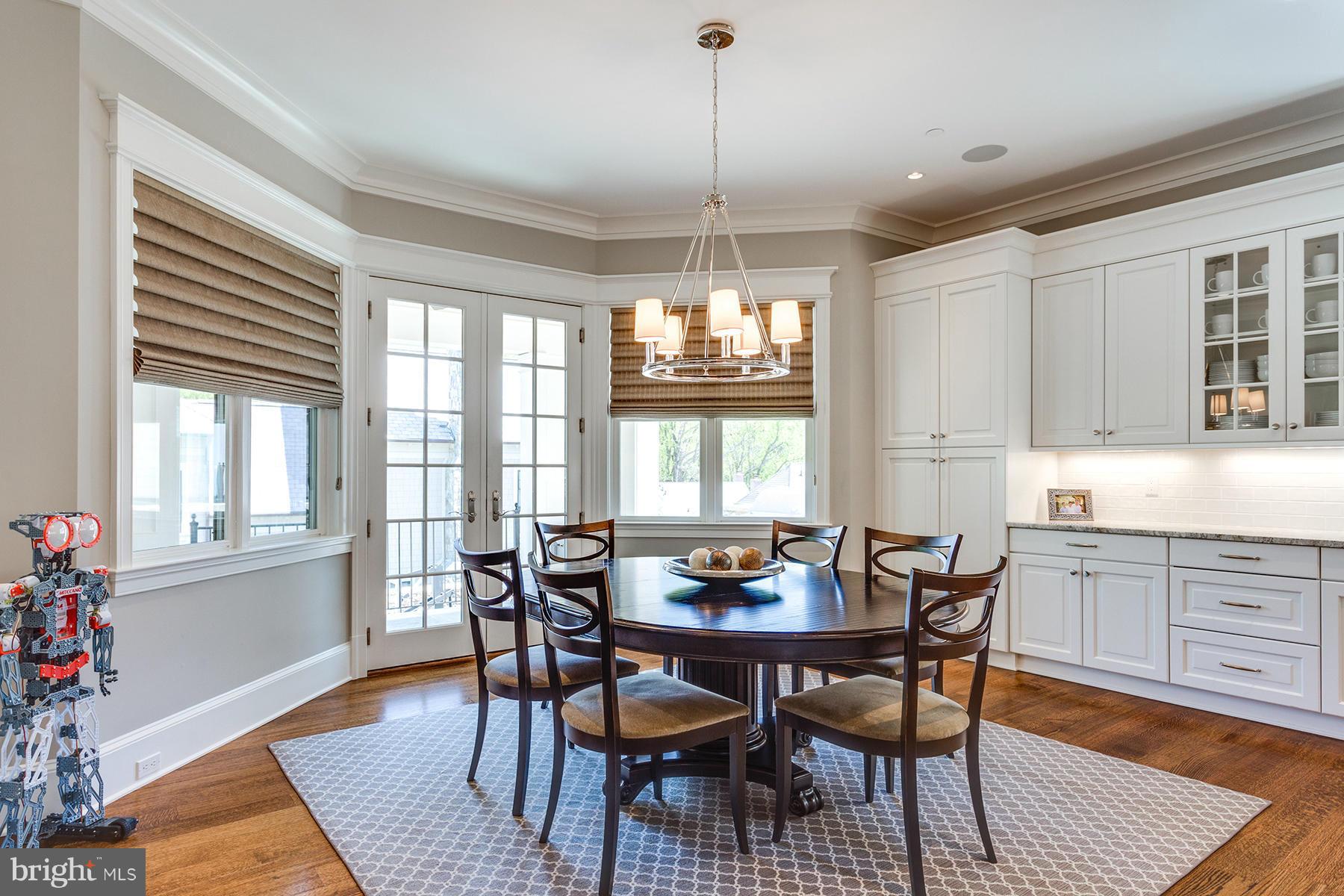 1909 Foxview Circle Northwest Washington, DC 20007 - Photo 13 of 30 a dining room with wooden floor a chandelier a wooden table and chairs