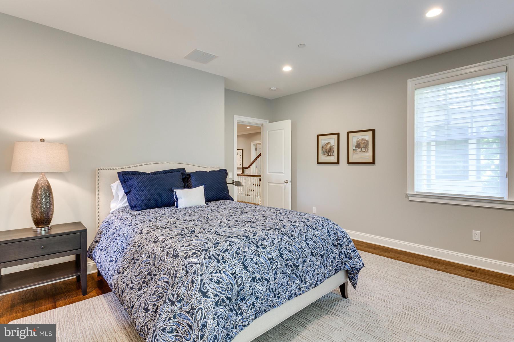 1909 Foxview Circle Northwest Washington, DC 20007 - Photo 18 of 30 a bedroom with a bed and wooden floor