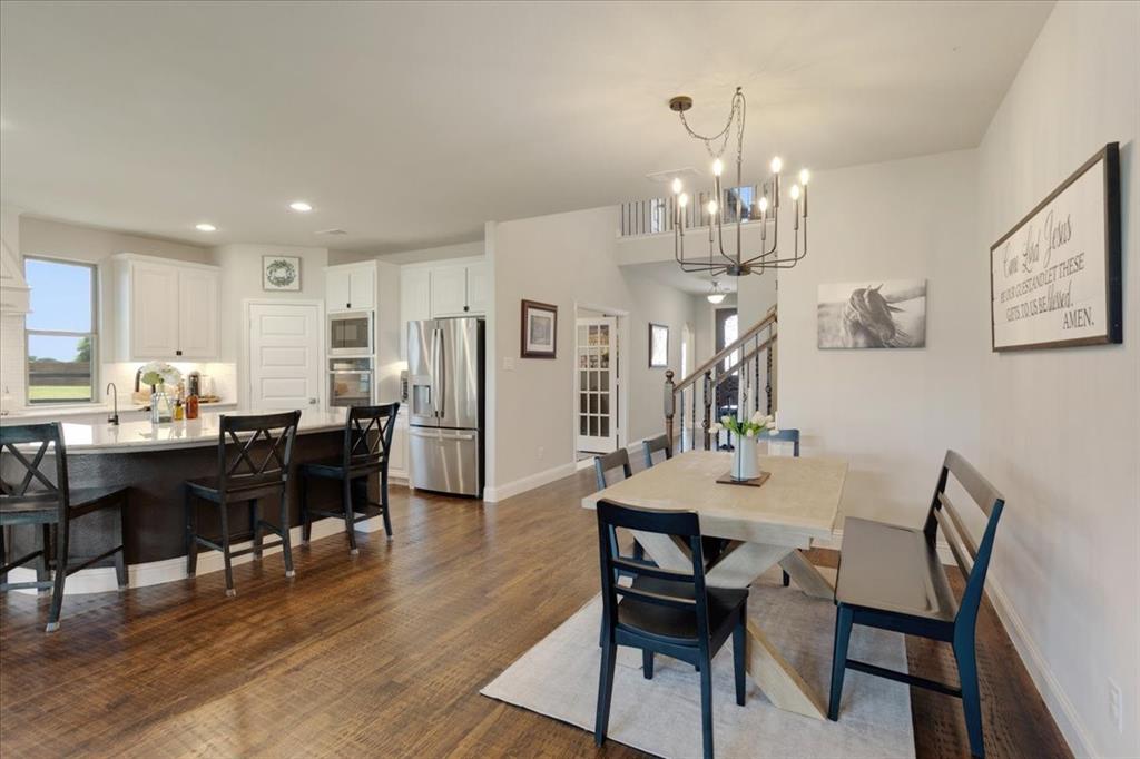 1205 Redbud Street Howe, TX 75459 - Photo 7 of 40 a view of a dining room with furniture and wooden floor