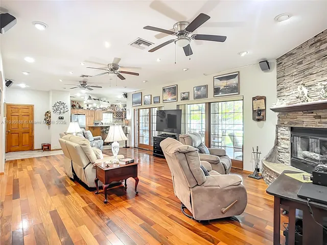 a kitchen with stainless steel appliances granite countertop a sink a stove and a refrigerator