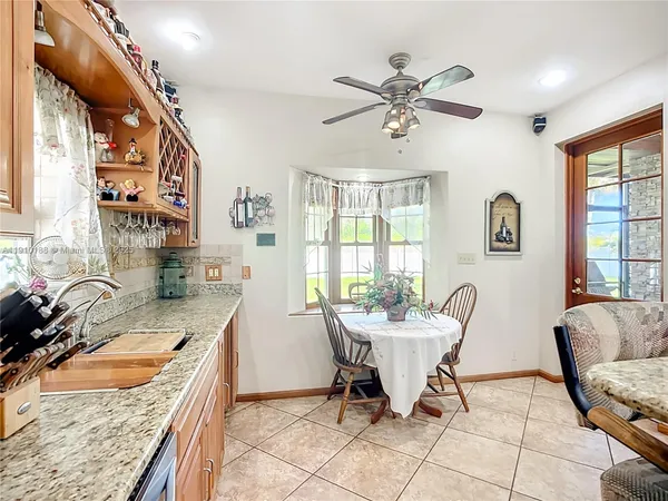 a view of a kitchen with a sink cabinets and wooden floor